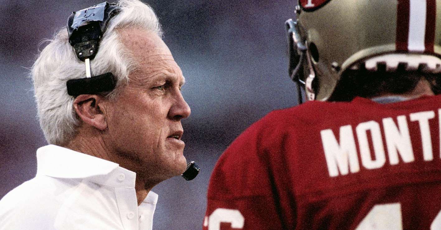 NFL coach Bill Walsh talking to a player